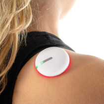 Woman carrying red and white device on her back for pain reduction.
