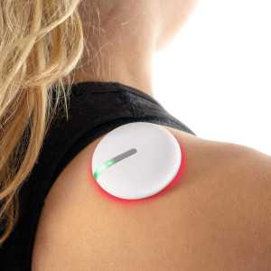 Woman carrying red and white device on her back for pain reduction.