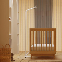 White phone with built-in light and camera, similar to Advanced Nanit Pro Smart Baby Monitor with Floor Stand.