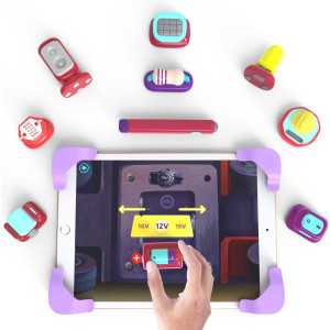 A person holding an iPad displaying the text "Build 30 3D gadgets using real figures" for Tacto Electronics by PlayShifu.